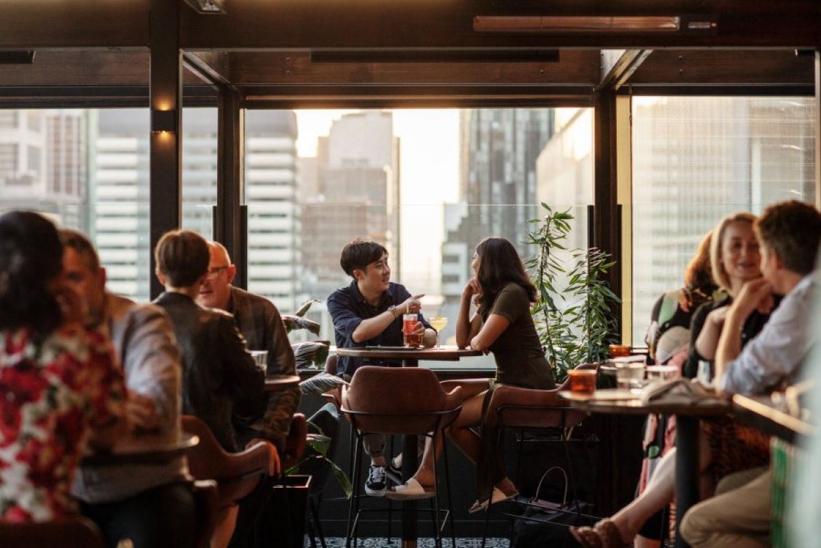 group of people drinking in a rooftop bar