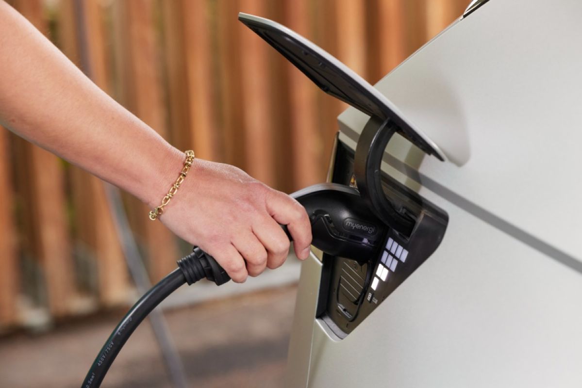 person pumping fuel into car