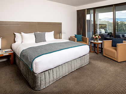 Mountain View Room at RACV Healesville Country Club and Resort, featuring a king bed, couches and balcony.