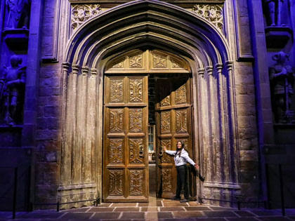 Woman posing at the entrance door of an attraction at Warner Bros. 