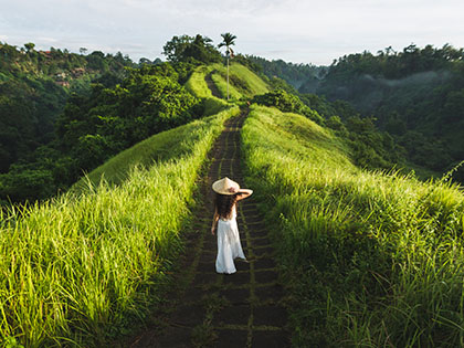 Woman walking on Campuhan Ridge way of artists, in Bali, Ubud.